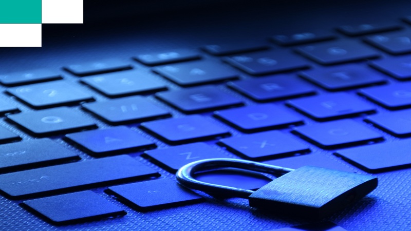 Physical padlock resting on a laptop keyboard